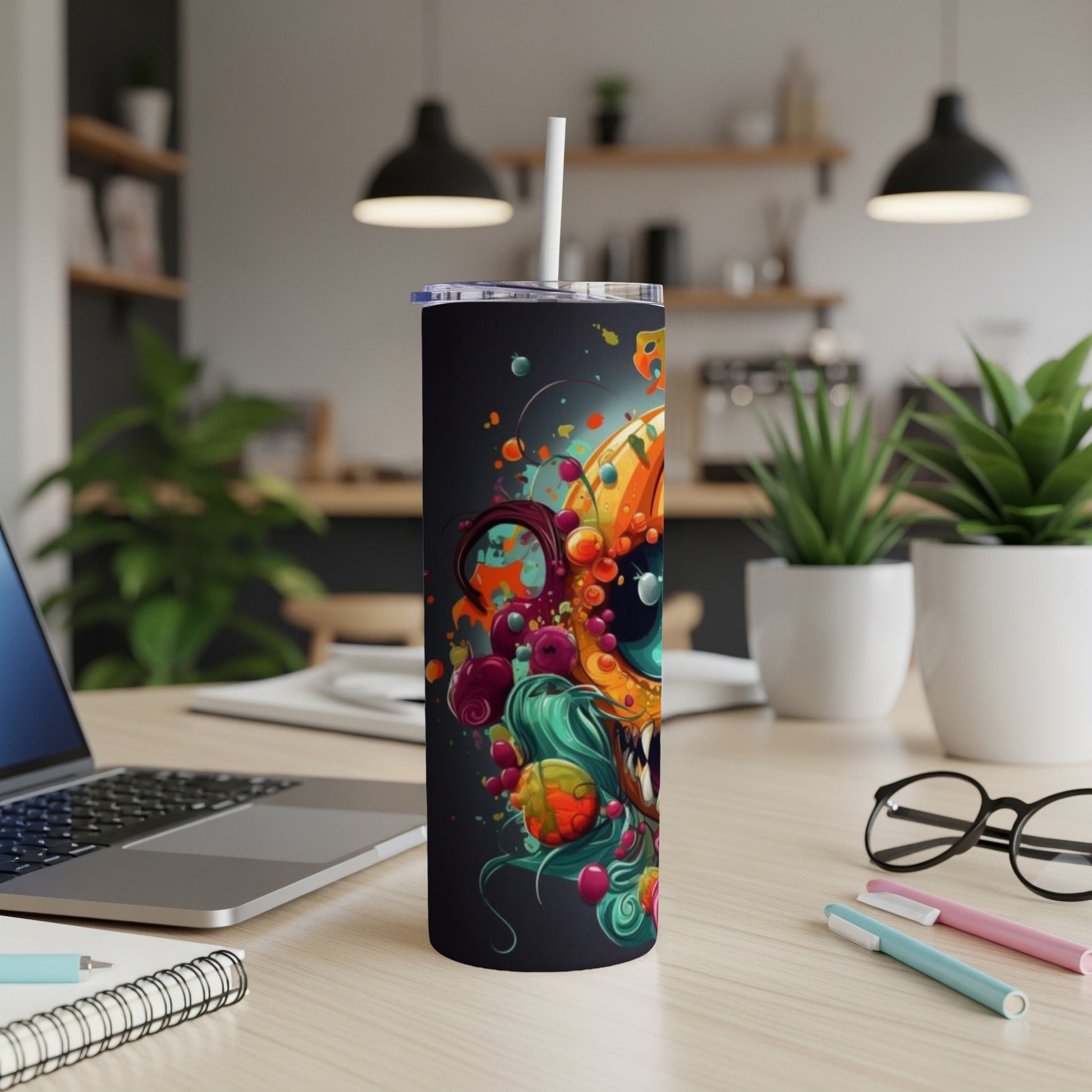 Tumbler with a vibrant, abstract monster design in orange, teal, and purple.