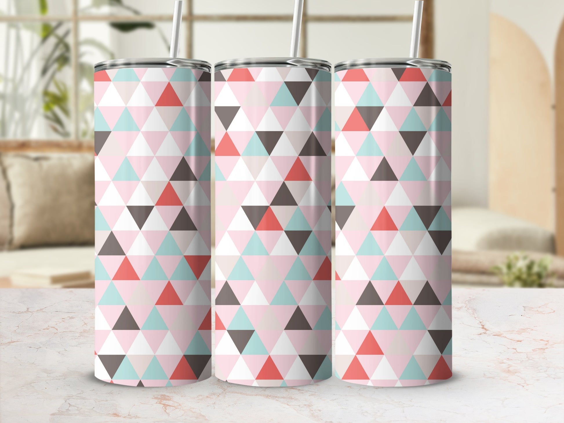 Three tumblers with pink, blue, gray, and coral geometric triangle pattern.