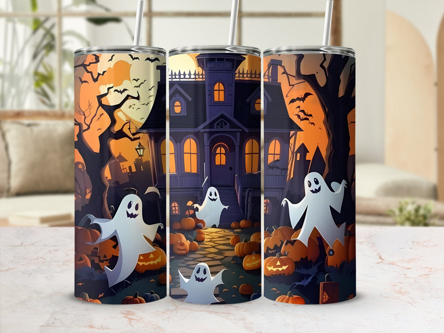 Three tumblers with a spooky haunted house, ghost, and pumpkin Halloween design.