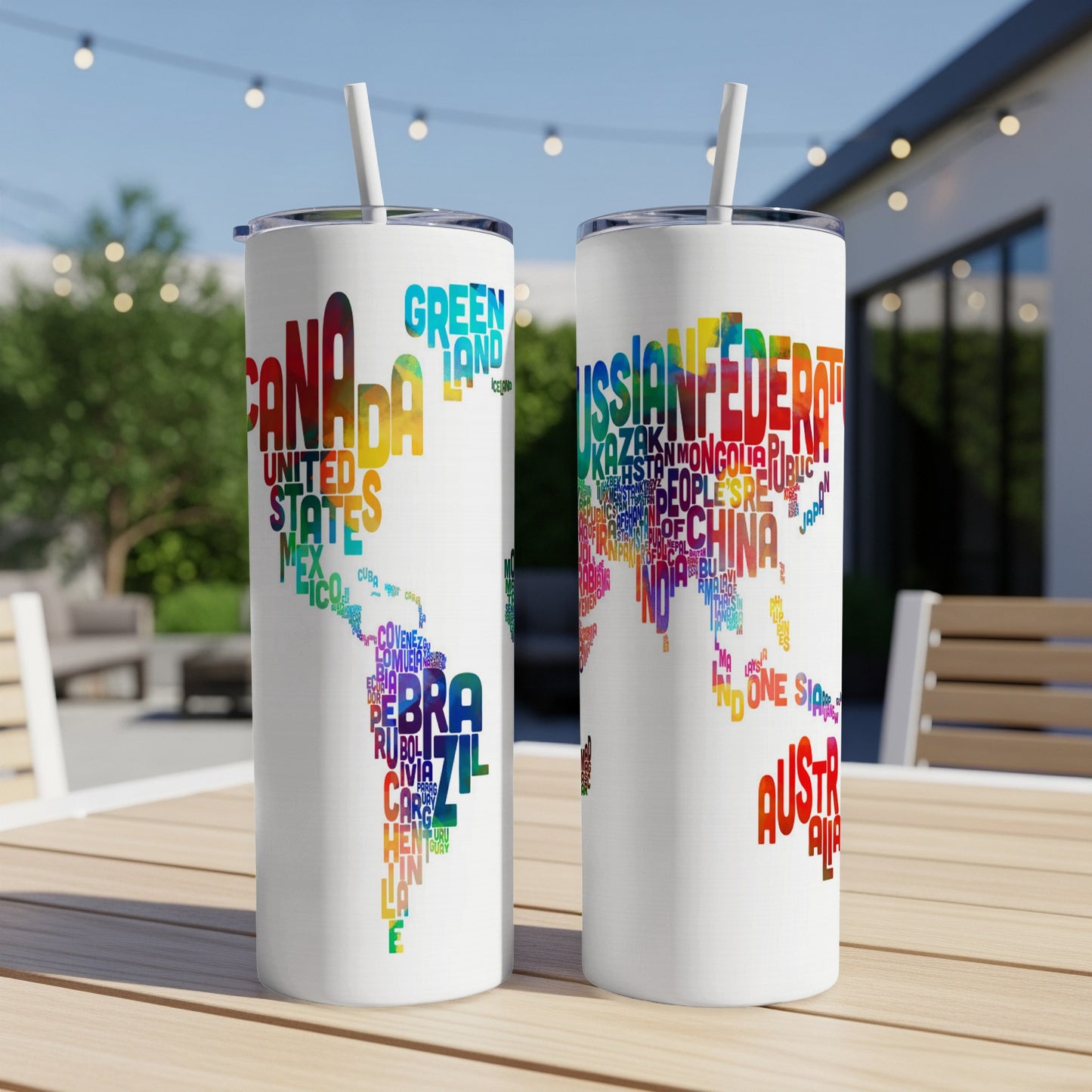 Two tumblers with world maps made of colorful country names and straws.