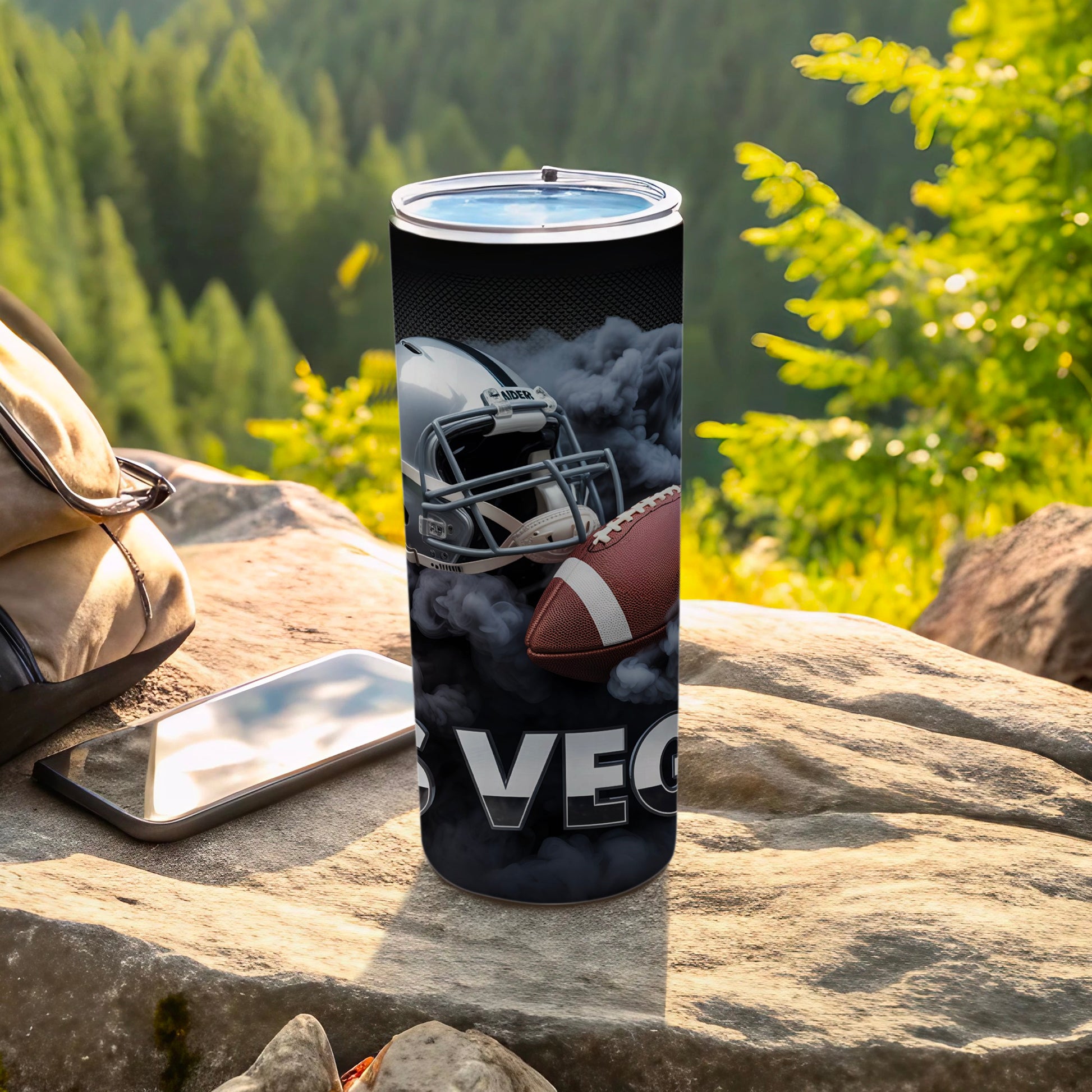 Football helmet and ball with "VEGAS" text on a smoky tumbler.