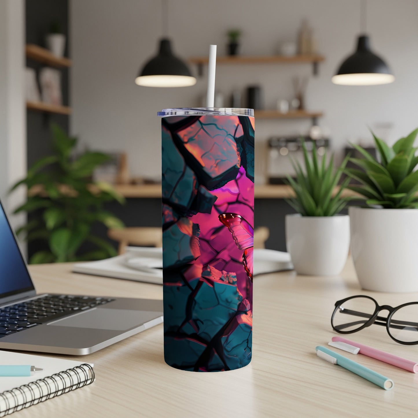 Tall tumbler with abstract, shattered glass design and a straw.
