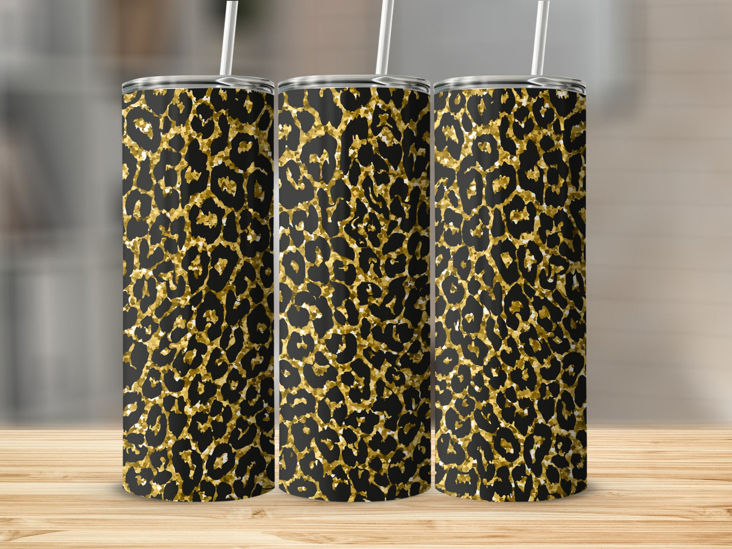 Three tall tumblers with black and gold leopard print patterns.