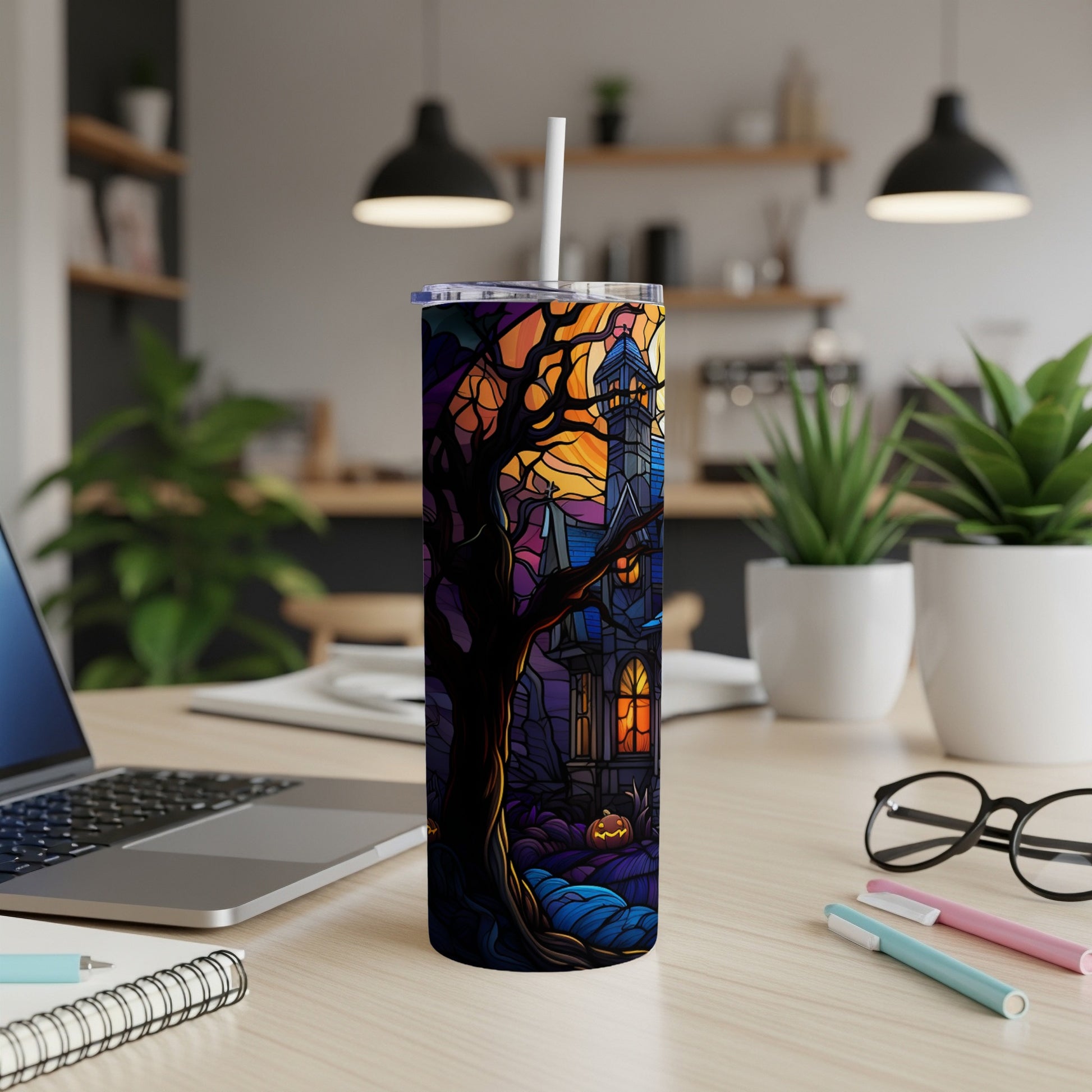 Halloween tumbler with spooky house and tree design.