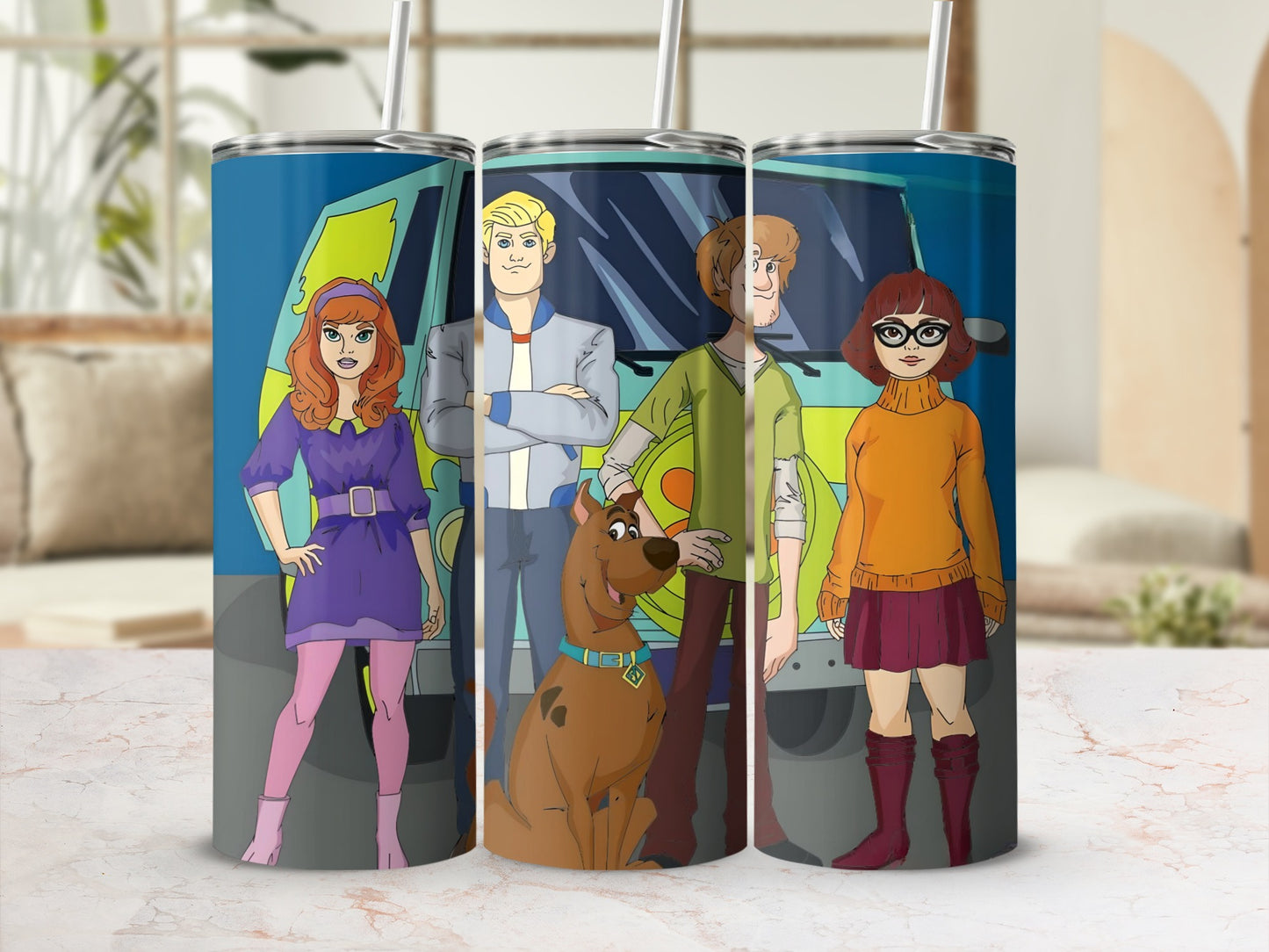 Scooby-Doo characters Daphne, Fred, Shaggy, Velma, and Scooby-Doo on a teal tumbler.