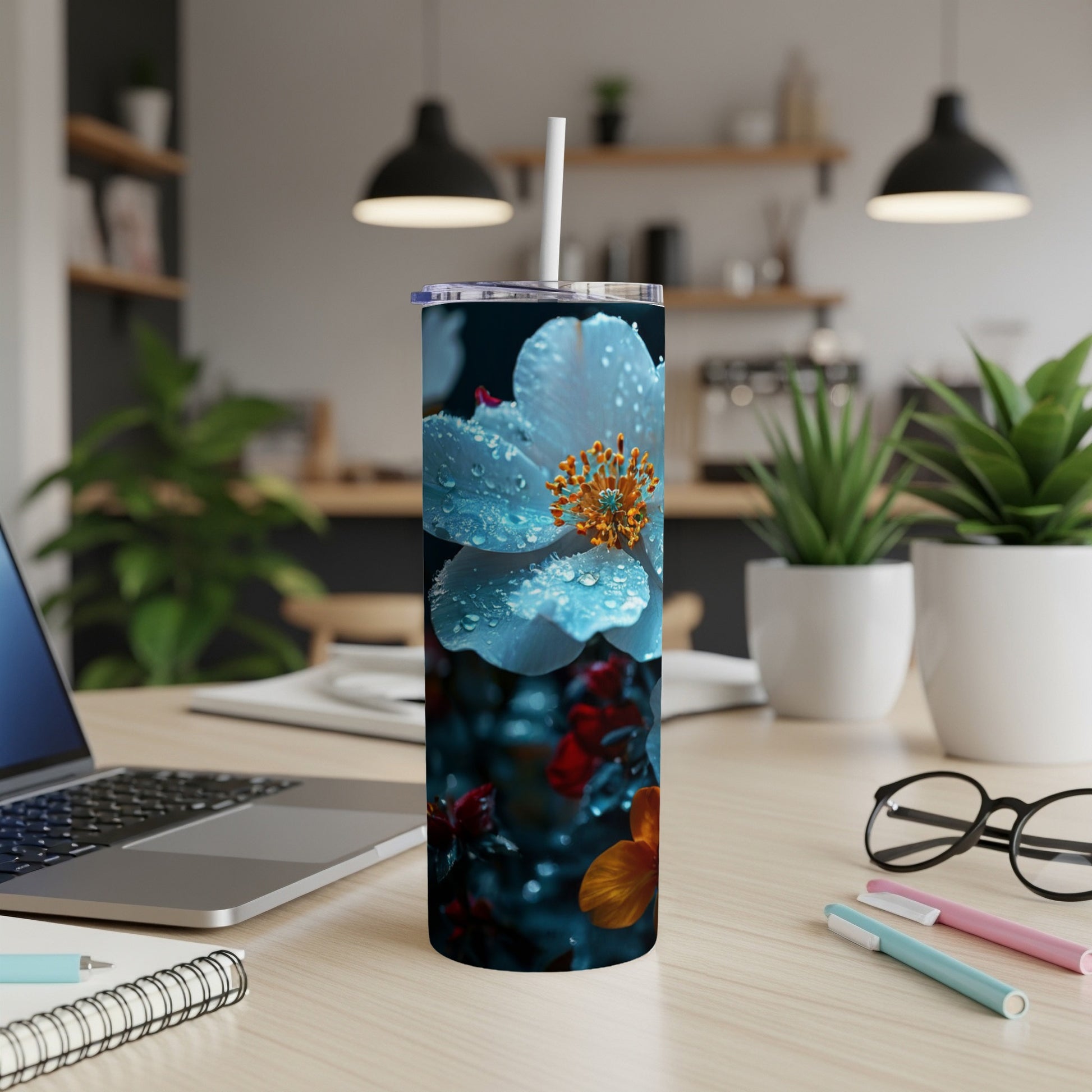Light blue flower with water droplets on a skinny tumbler.