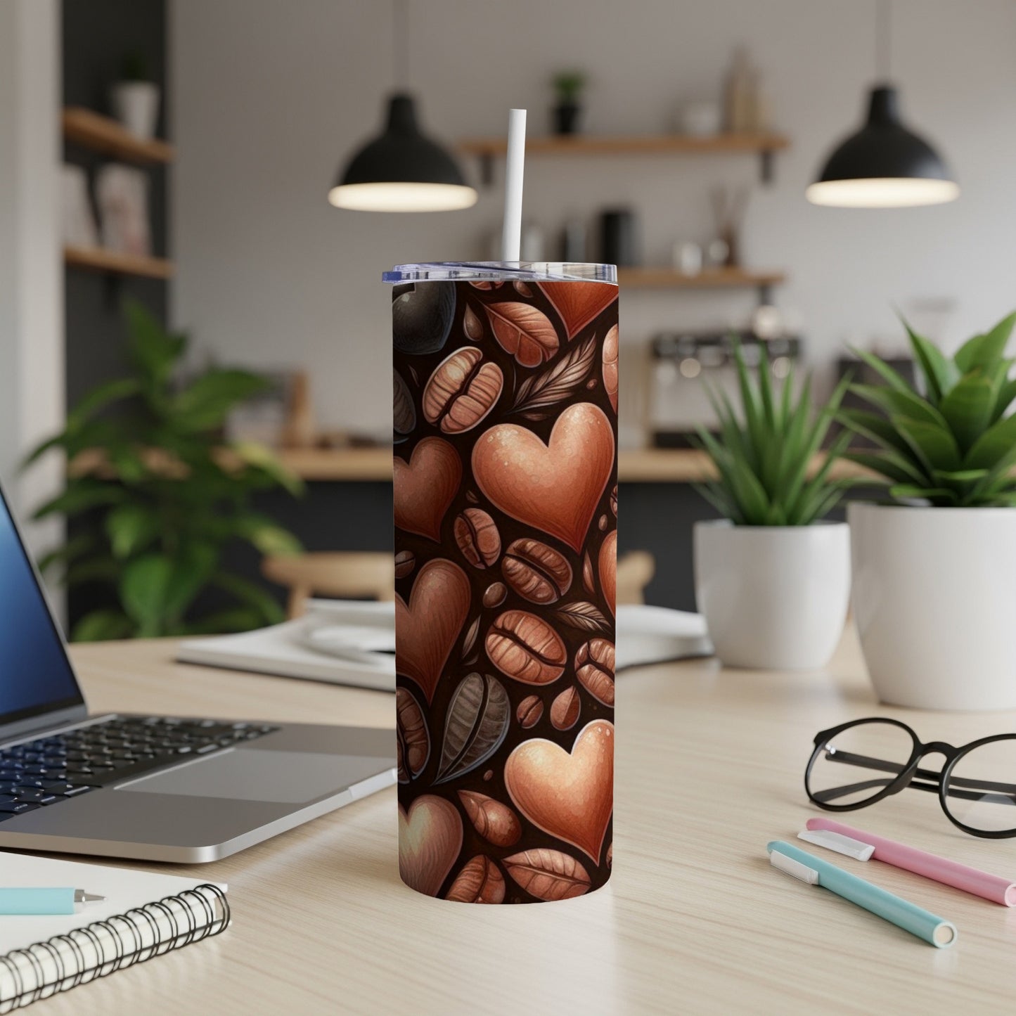 Tall stainless steel tumbler with coffee beans and hearts pattern.