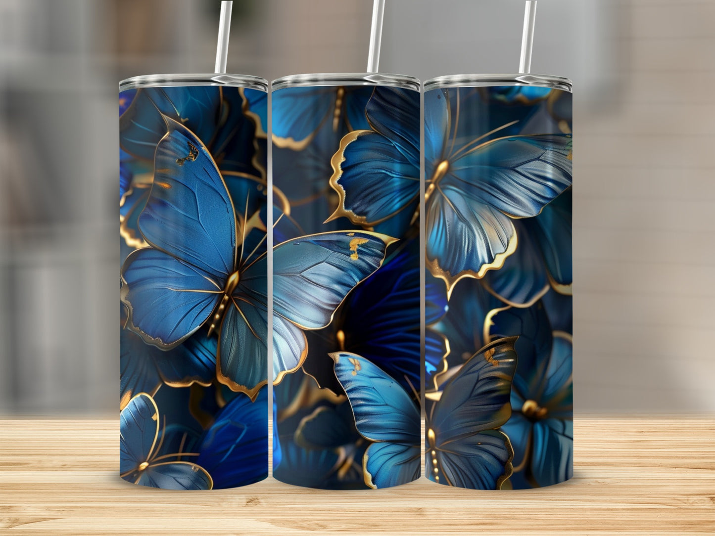 Three tumblers with blue butterflies and gold accents.