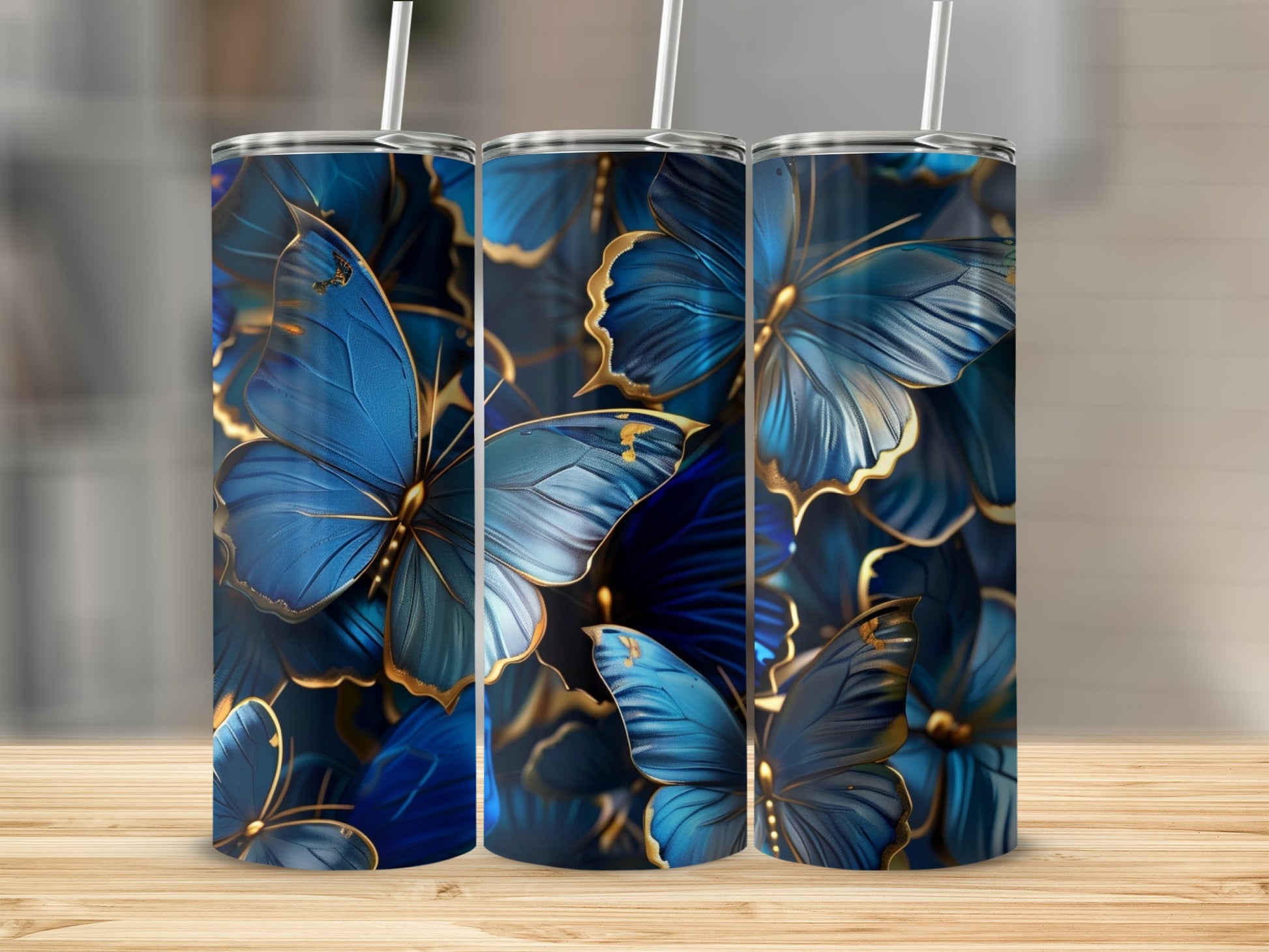 Three tumblers with blue butterflies and gold accents.