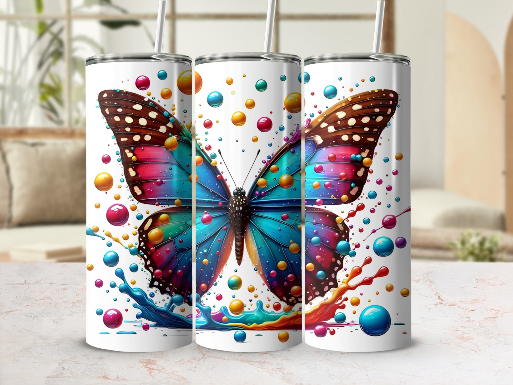 Three tumblers featuring a vibrant butterfly design with colorful bubbles.