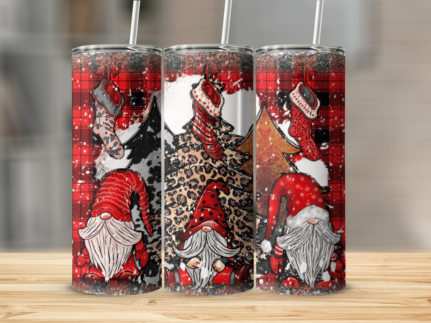 Three Christmas gnomes with red hats on a plaid and leopard print background.