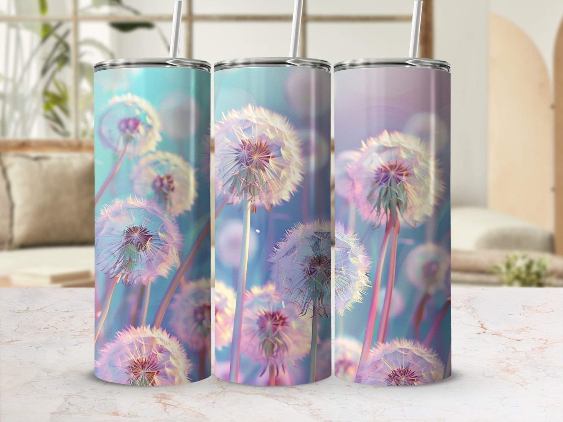 Three tall tumblers with dandelion designs on a marble surface.