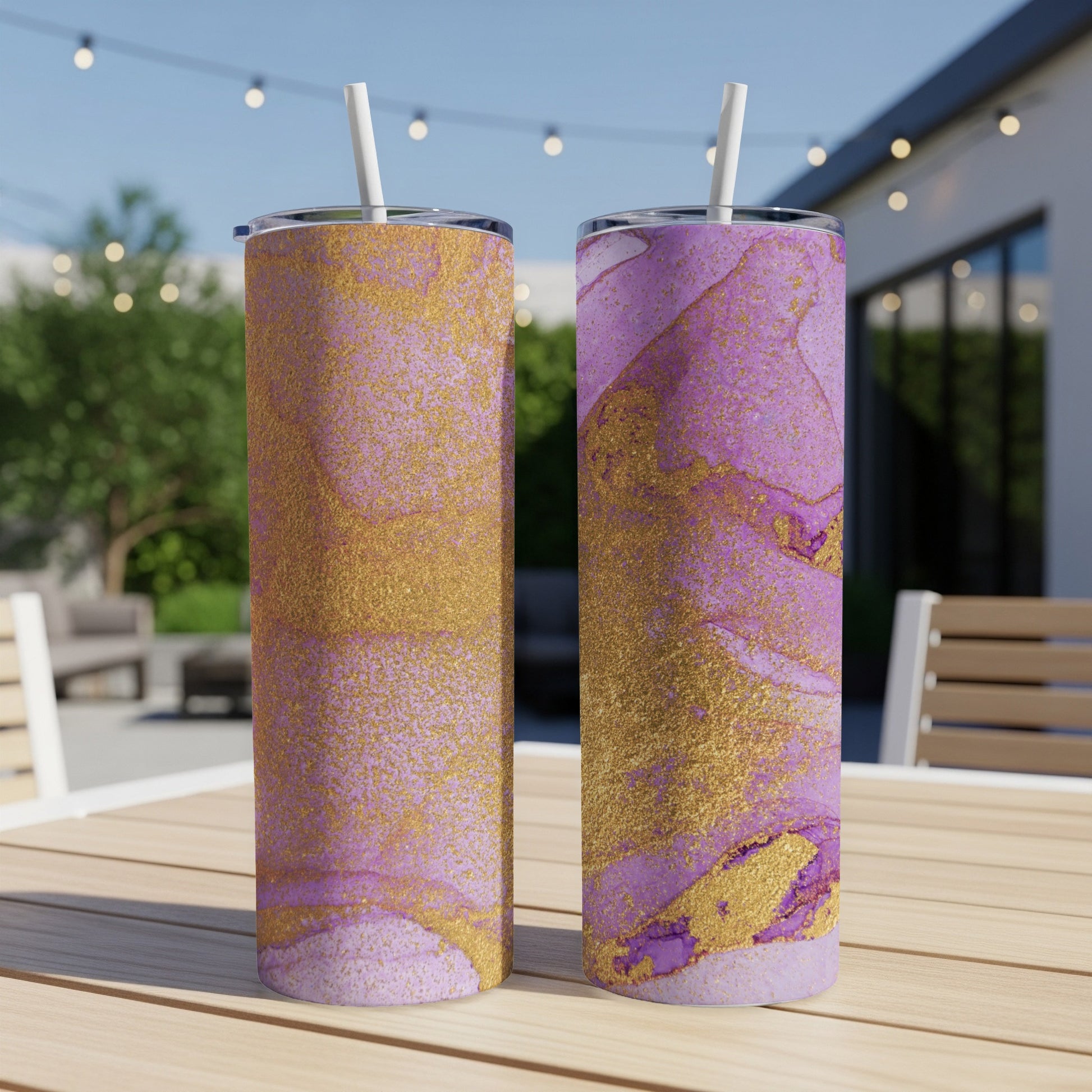 Two tumblers with purple and gold marbled design on a wooden table.