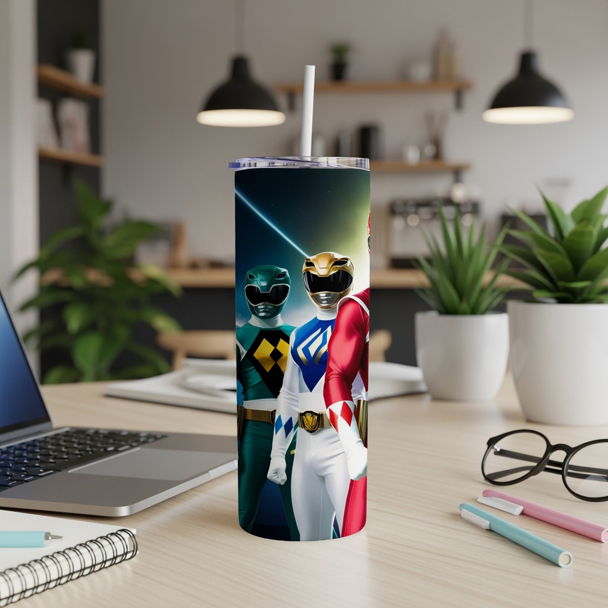 Power Rangers in formation on a tumbler with a laptop and office supplies.