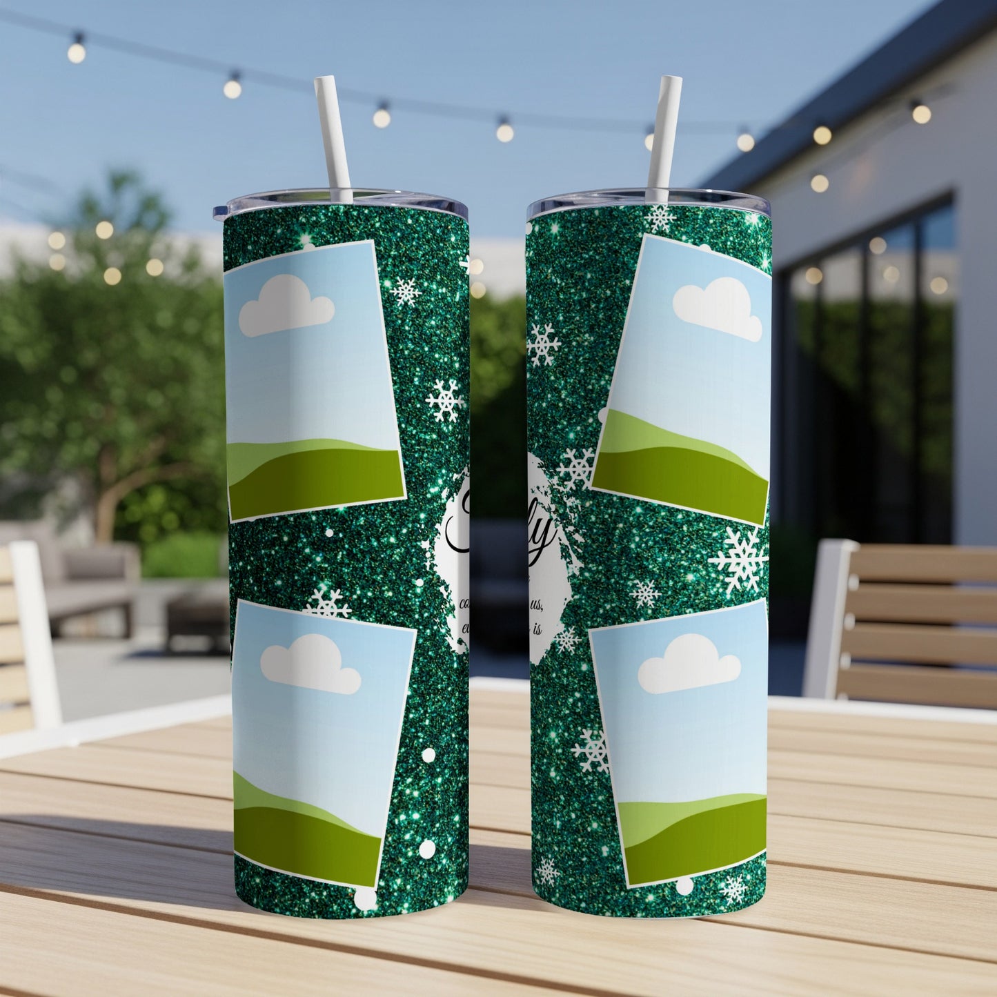 Two glitter green tumblers with photo frames, snowflakes, and text on a wooden table.