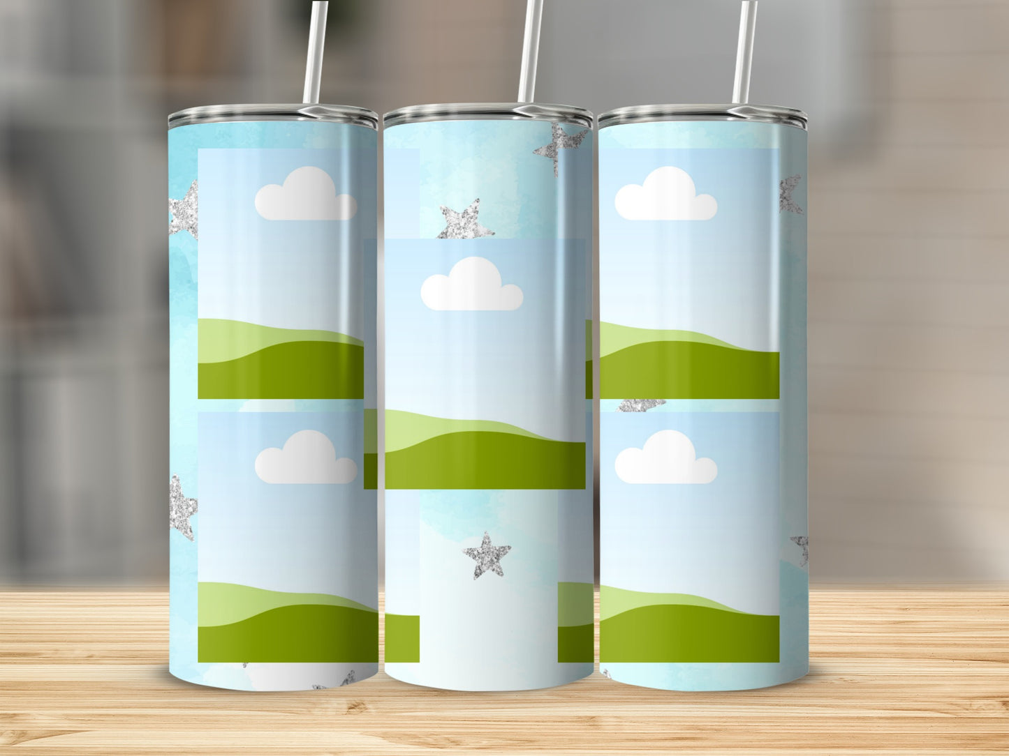 Three tumblers with a blue sky, clouds, green hills, and glittery stars design.