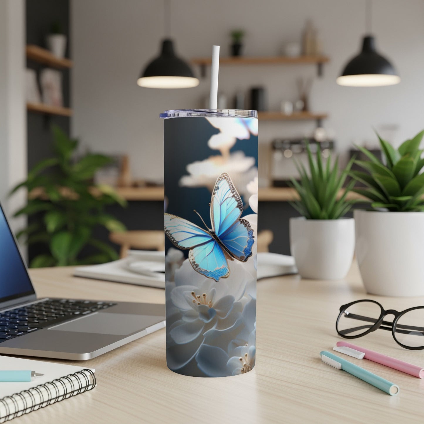 Blue butterfly on white flowers design on a skinny tumbler.