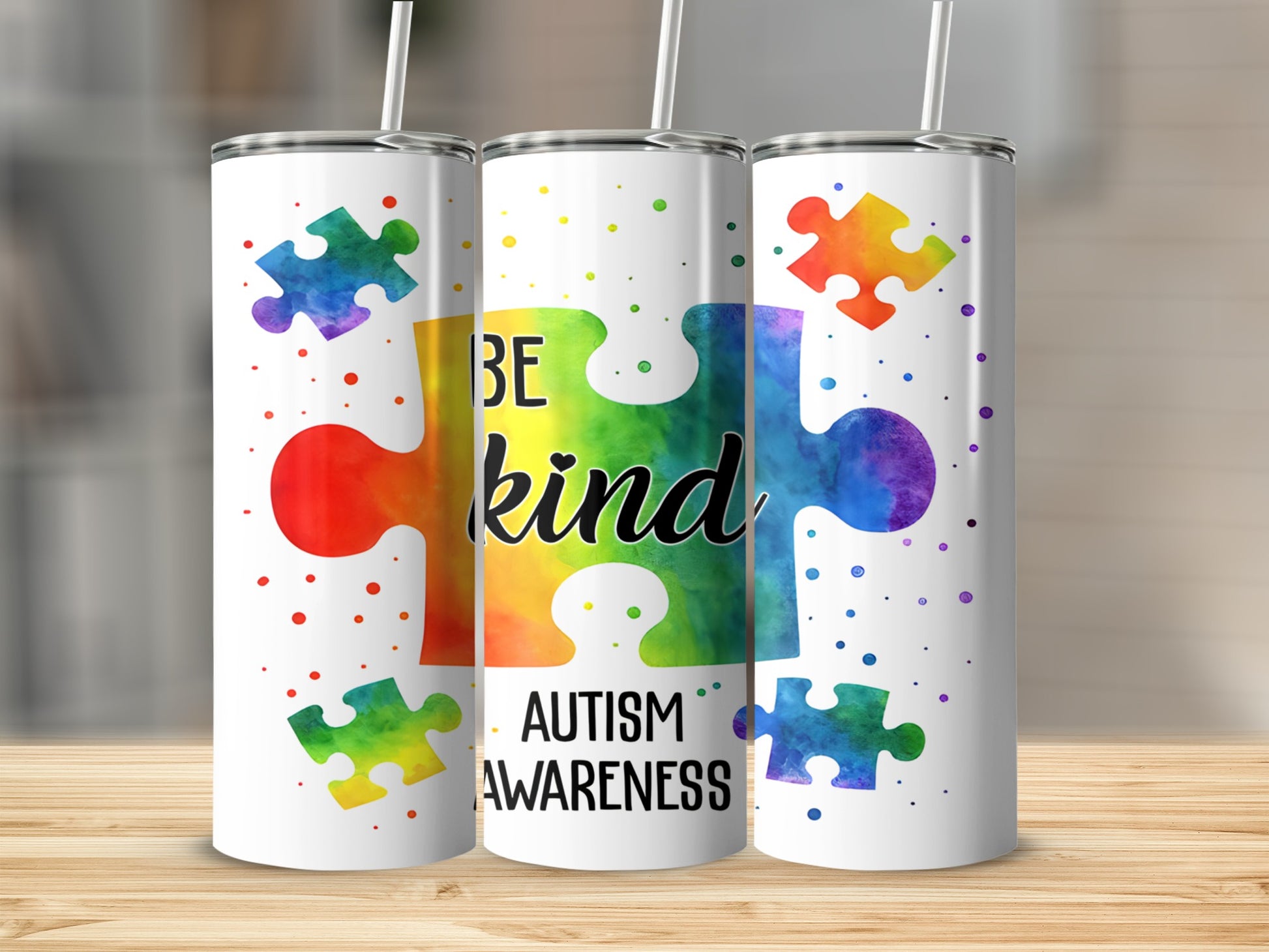 Rainbow puzzle pieces with "Be Kind Autism Awareness" text on a tumbler.