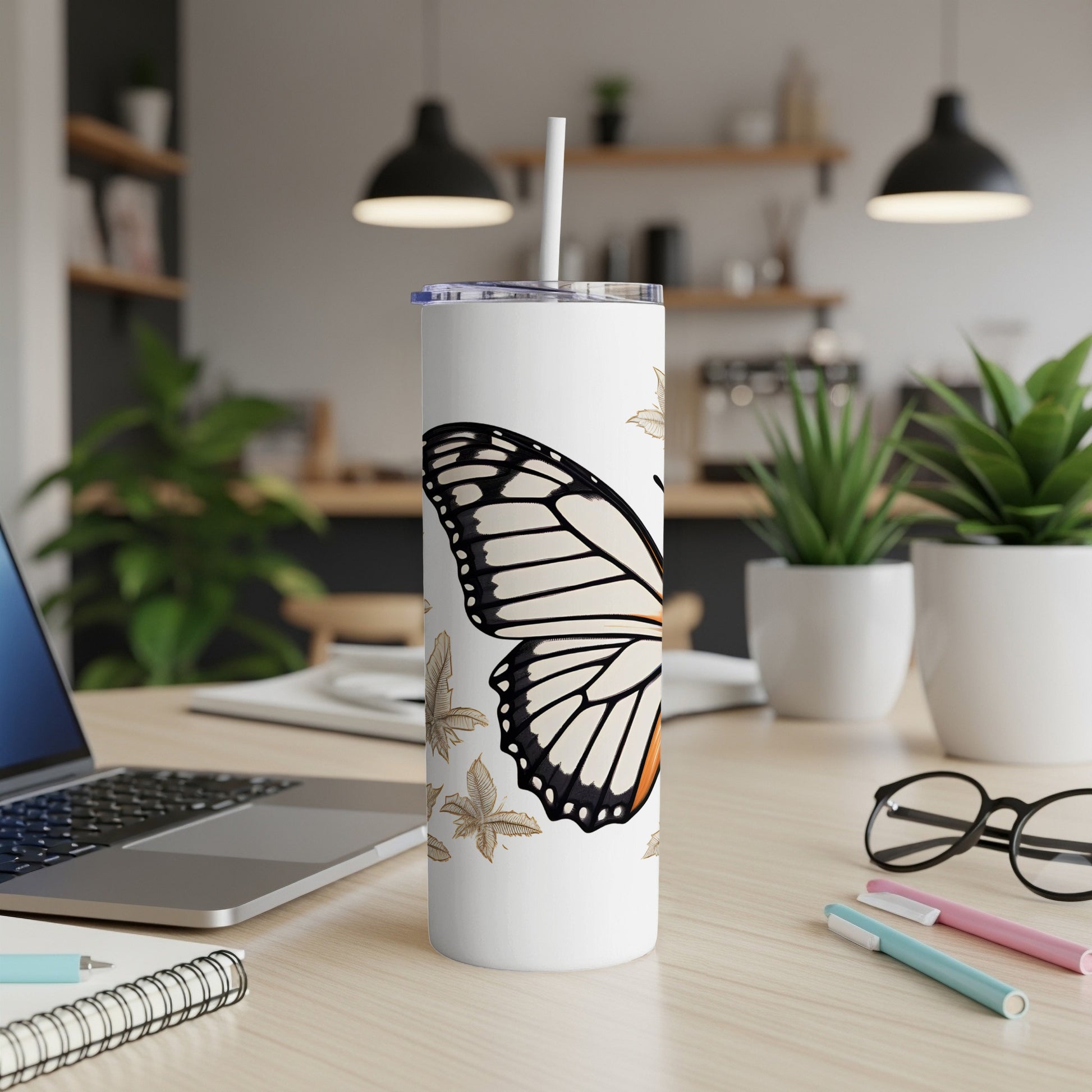 White tumbler with monarch butterfly and falling leaves design.