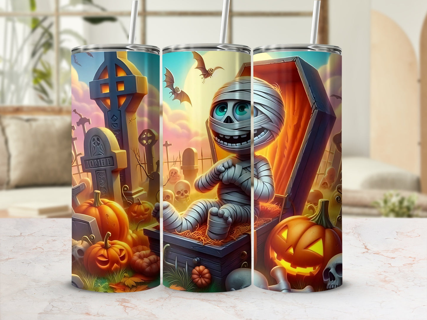 Halloween tumbler with mummy, pumpkins, gravestones, and bats.