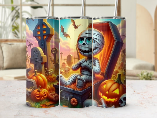 Halloween tumbler with mummy, pumpkins, gravestones, and bats.