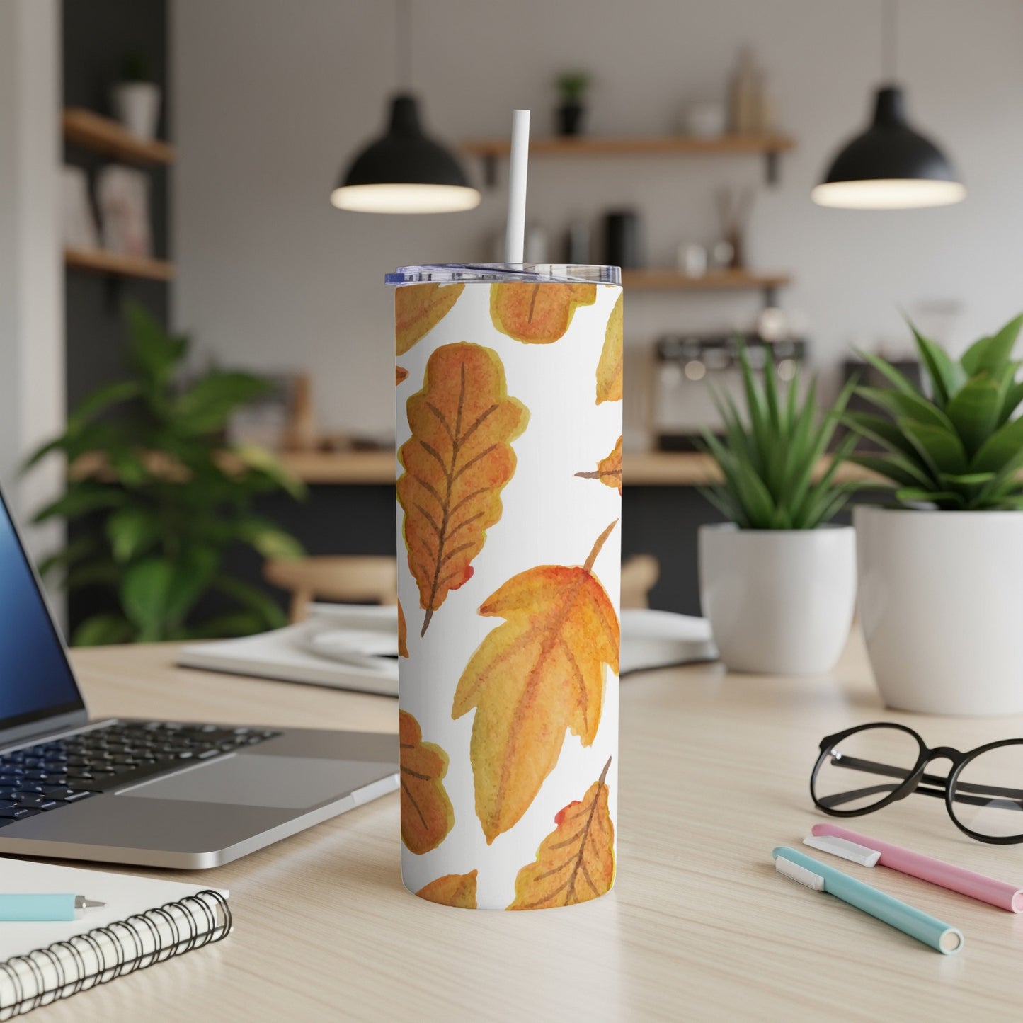 White tumbler with a repeating pattern of watercolor oak leaves.