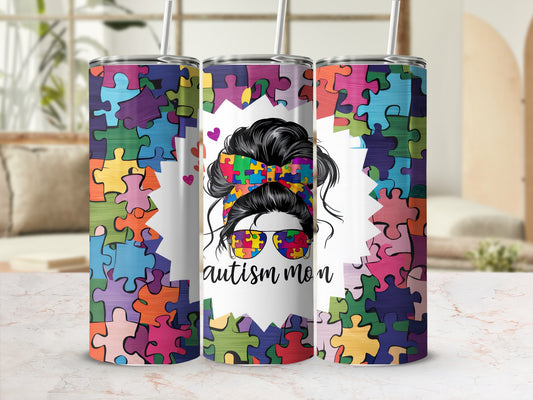 Autism mom tumbler with colorful puzzle piece design and messy bun.