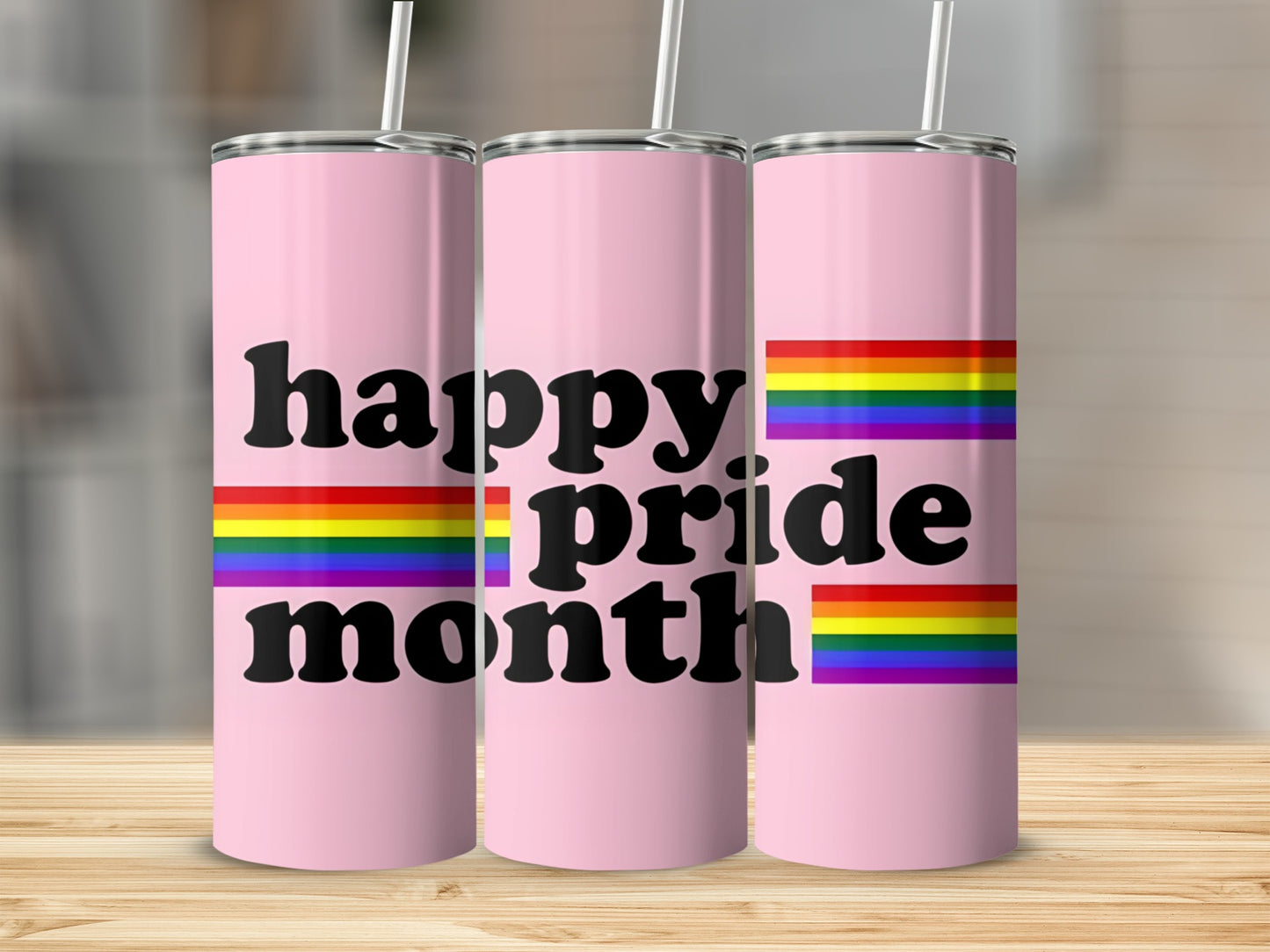 Pink tumbler with "happy pride month" and rainbow stripes.