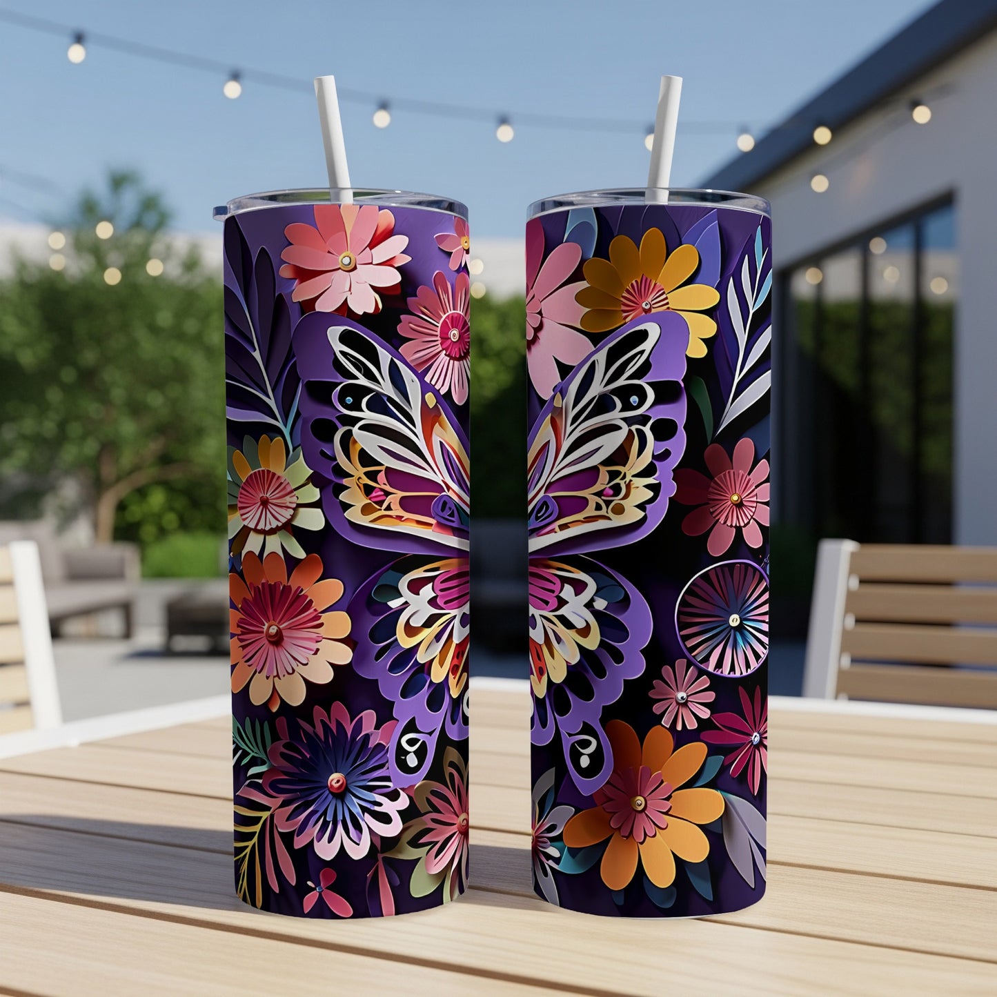 Two purple tumblers with butterfly and floral designs stand on a wooden table outdoors.