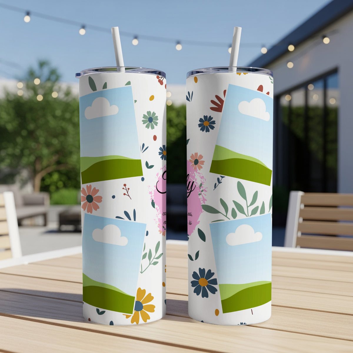 Two white tumblers with floral patterns and framed sky landscapes, sitting on a table.