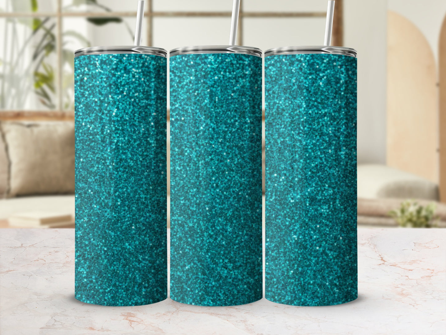 Three teal glitter tumblers with straws on a marble surface.