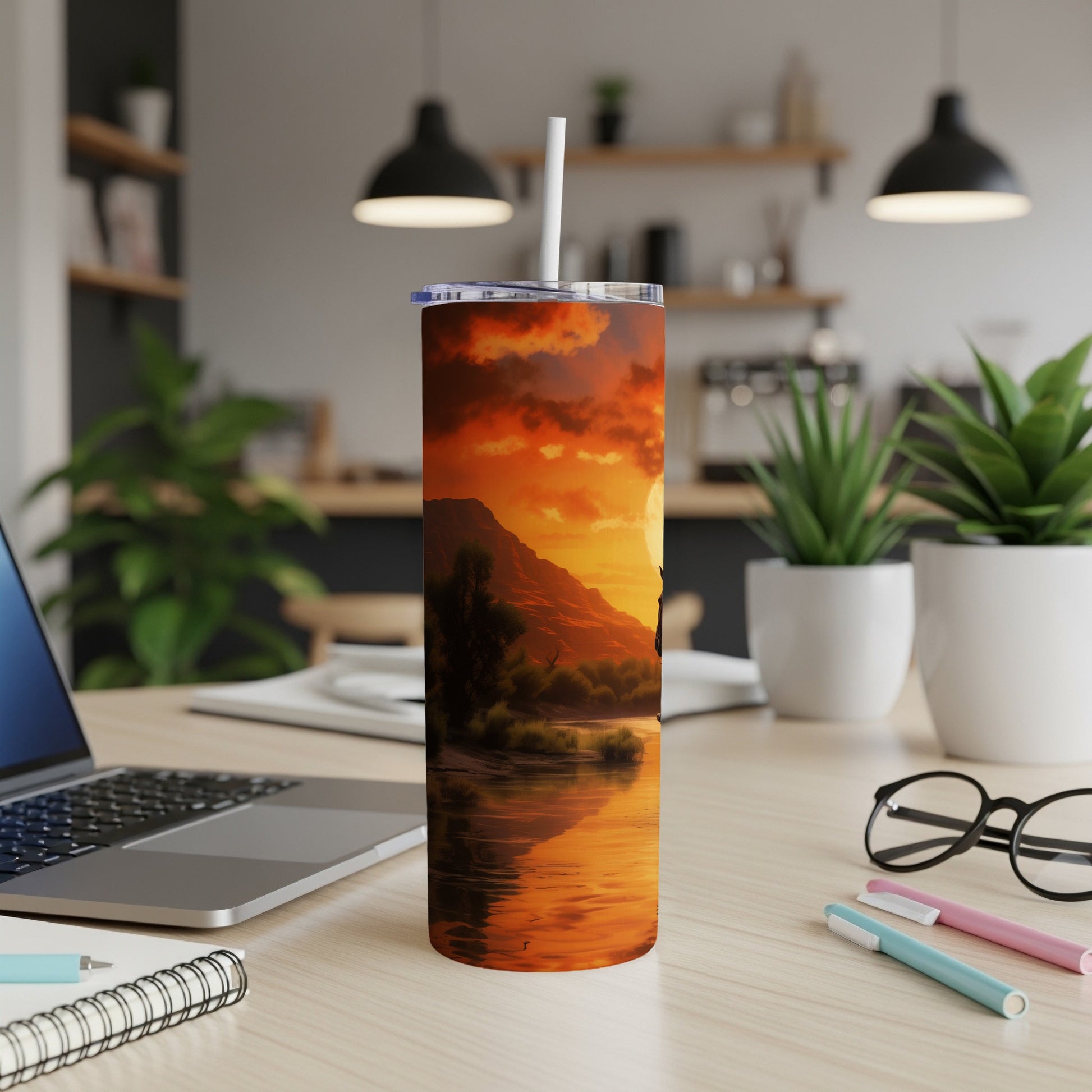 Sunset over a river with mountains and trees, on a tumbler.