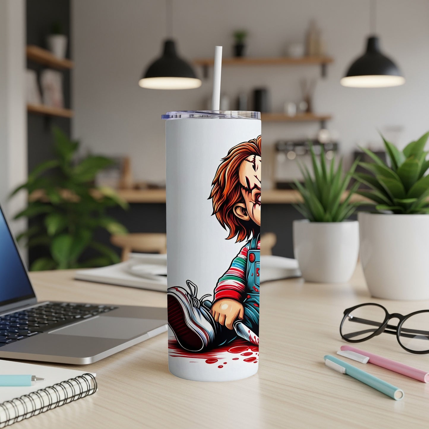 White tumbler with Chucky character artwork, holding a knife and sitting in blood.