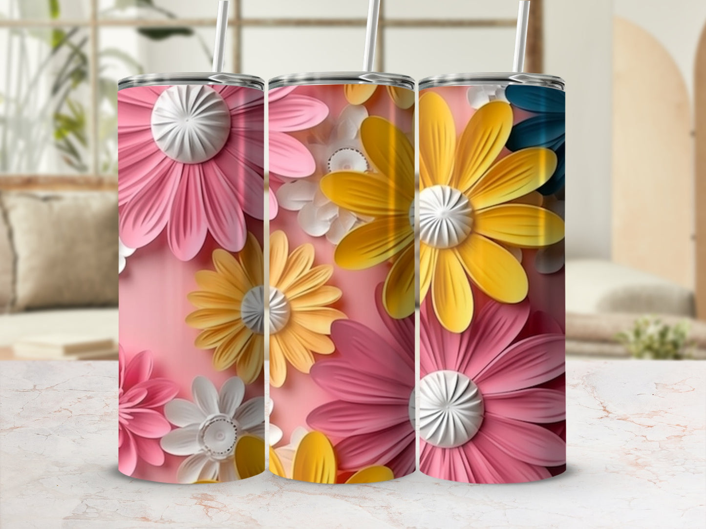 Three tumblers with pink, yellow, and white floral designs on a pink background.