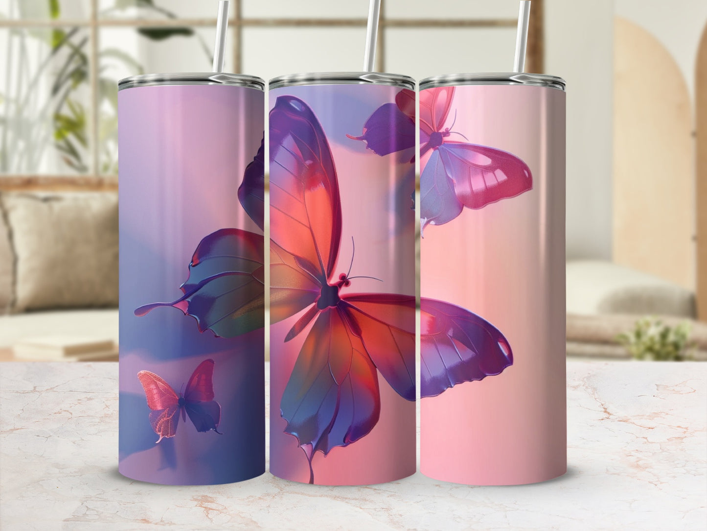 Three tumblers with iridescent butterfly designs on a marble surface.