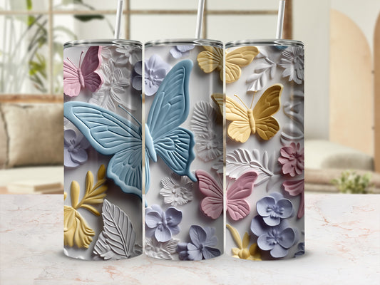 Three tumblers with pastel butterfly and floral designs.