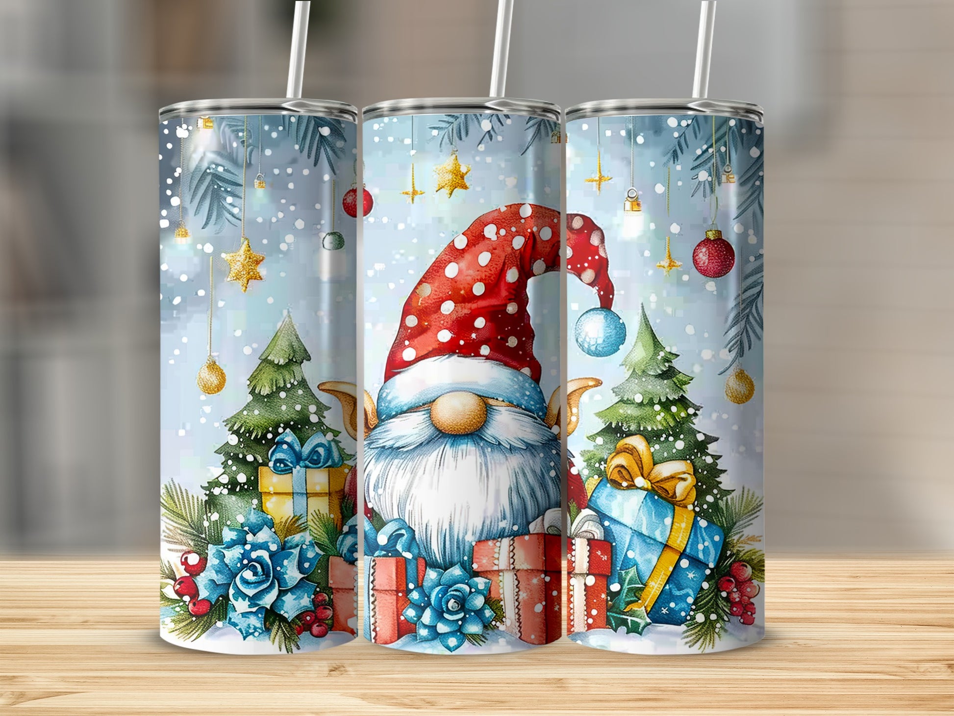 Christmas gnome with gifts and trees in snowy scene on three tumblers.