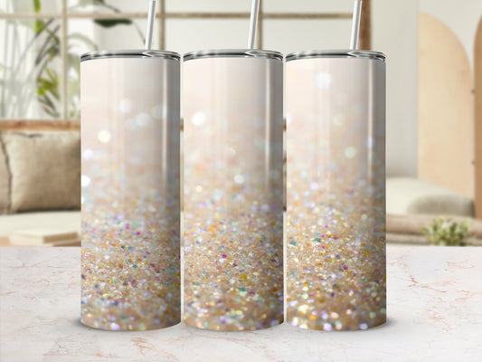 Three iridescent glitter tumblers with straws, displayed on a marble surface.
