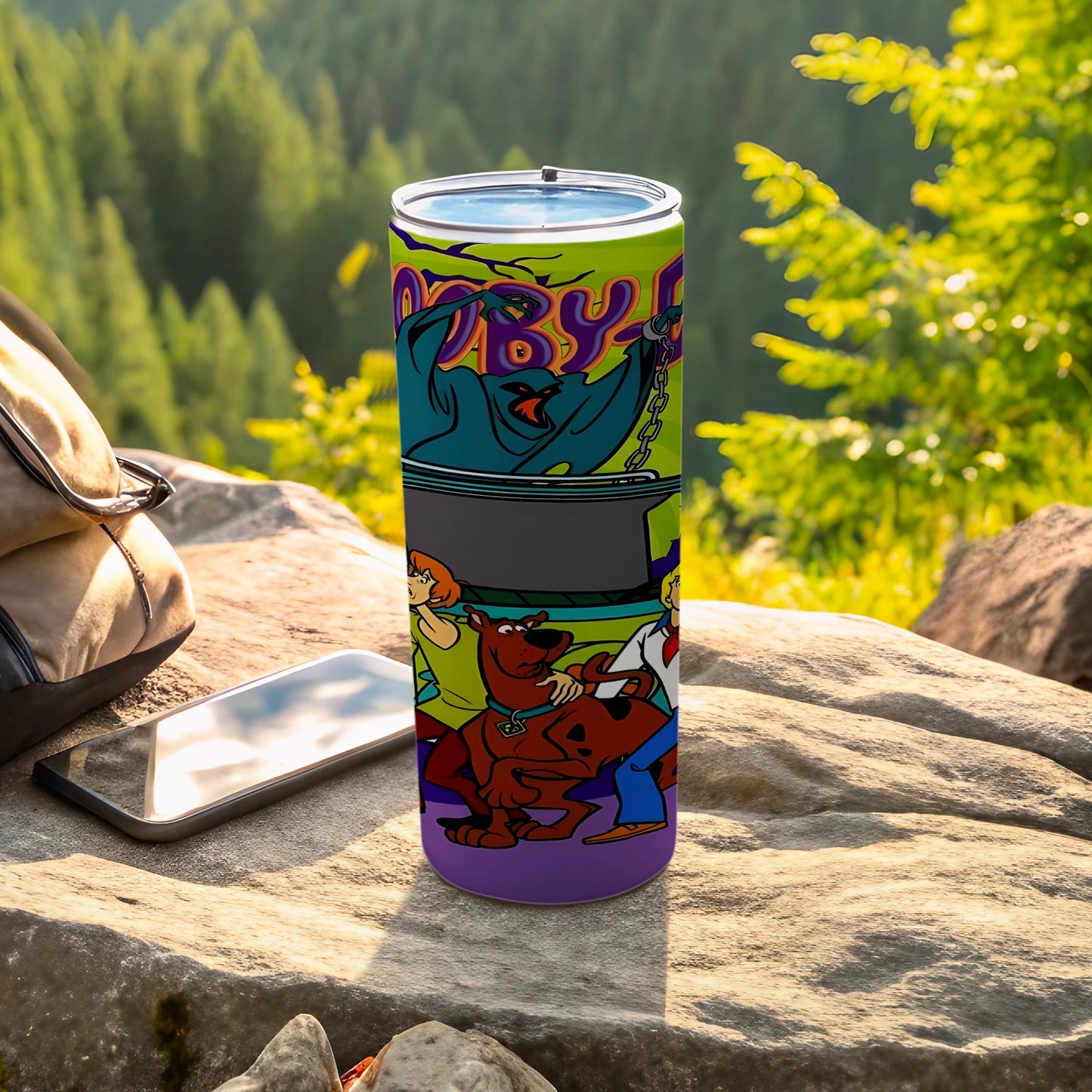 Scooby-Doo characters on a purple tumbler with a mountain landscape.