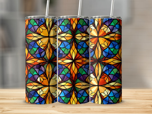 Three stained glass tumblers with a floral pattern on a wooden surface.