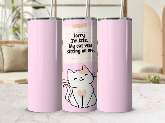 Pink tumbler with cat illustration and text "Sorry I'm late. My cat was sitting on me."