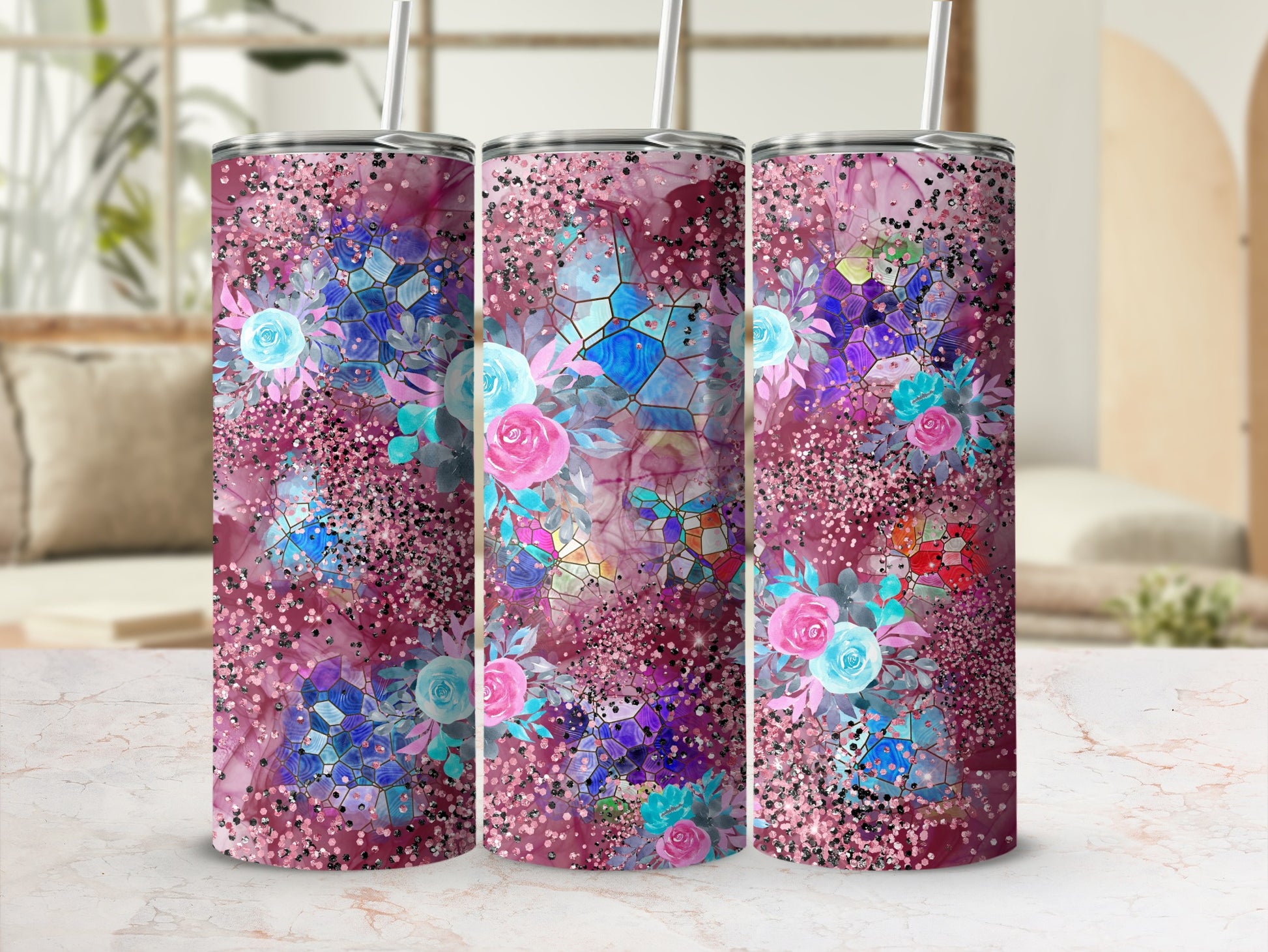 Three floral tumblers with glitter accents and abstract geometric patterns.