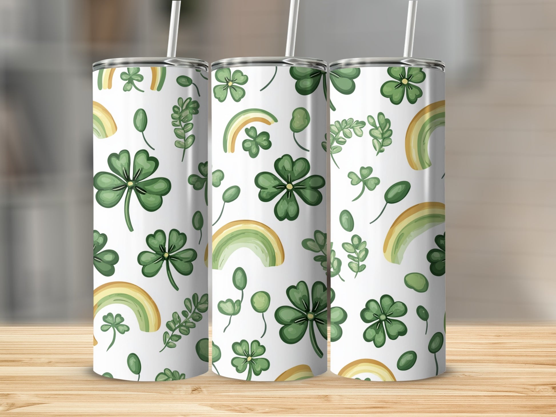 Pattern of shamrocks, leaves, and rainbows on three tumblers.