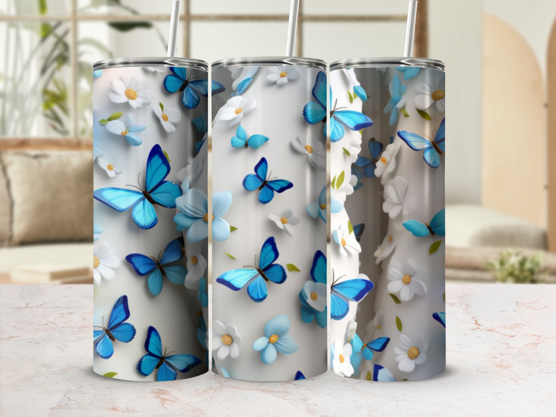 Three tumblers with blue butterflies and white flowers.
