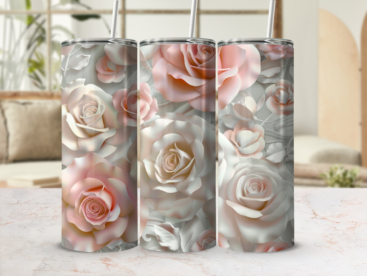 Pink and white roses pattern on three stainless steel tumblers.