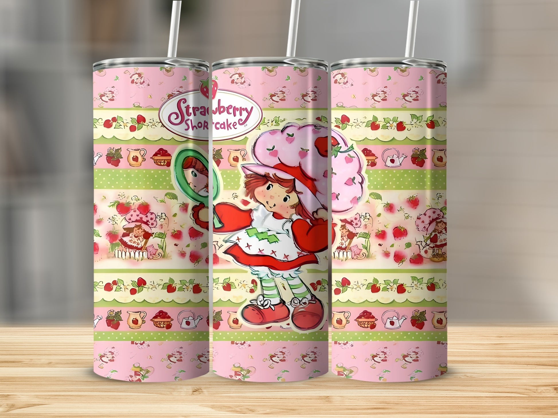 Strawberry Shortcake character on a pink tumbler with fruit and striped patterns.