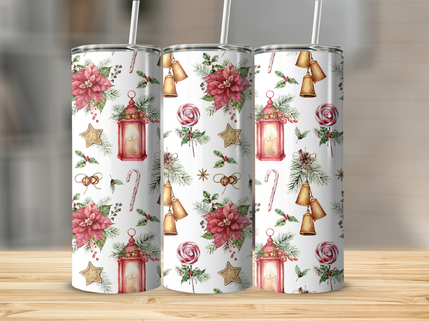 Three tumblers with a Christmas pattern of poinsettias, lanterns, candy canes, and bells.
