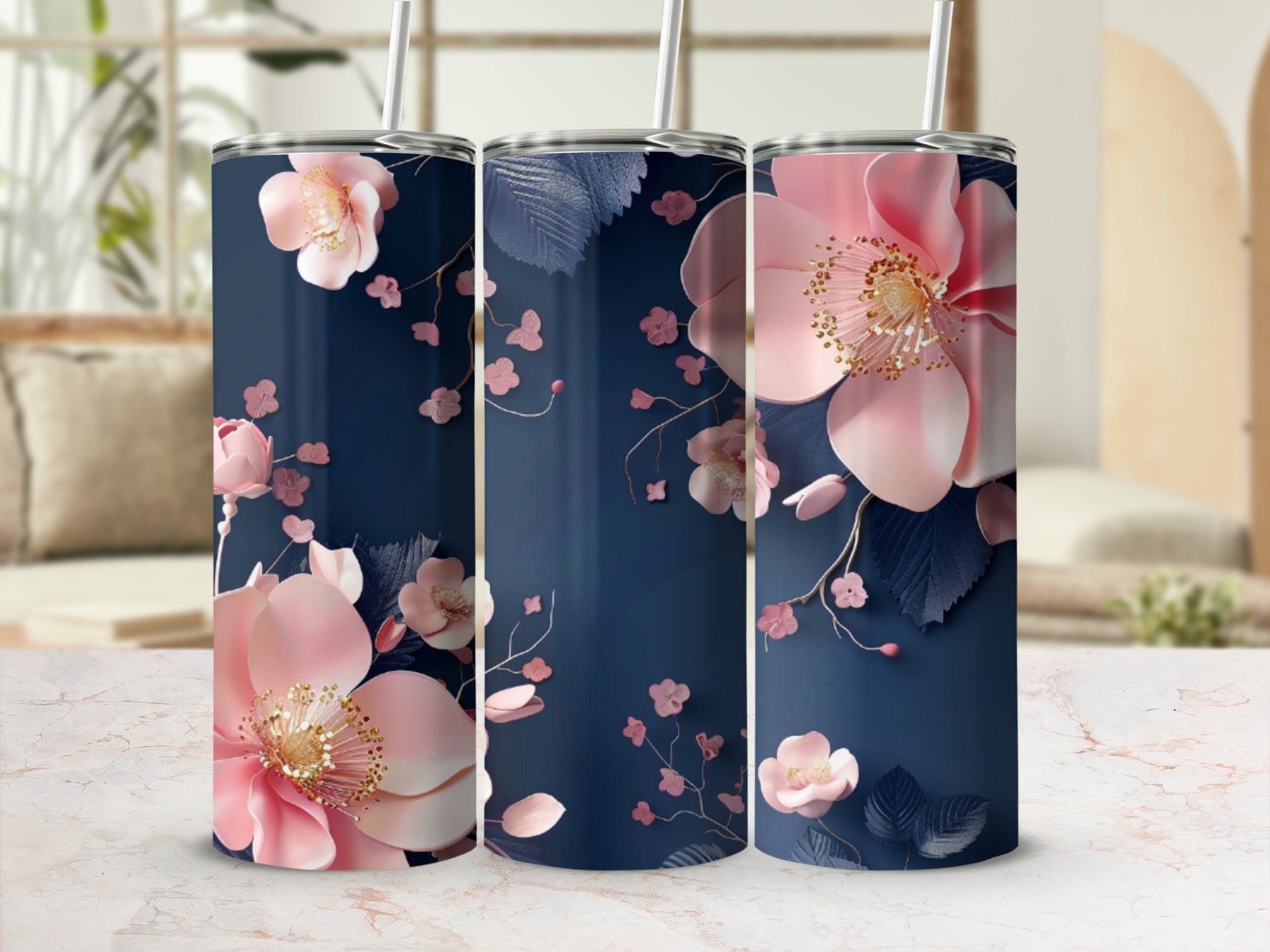 Three navy tumblers with pink floral and leaf designs.