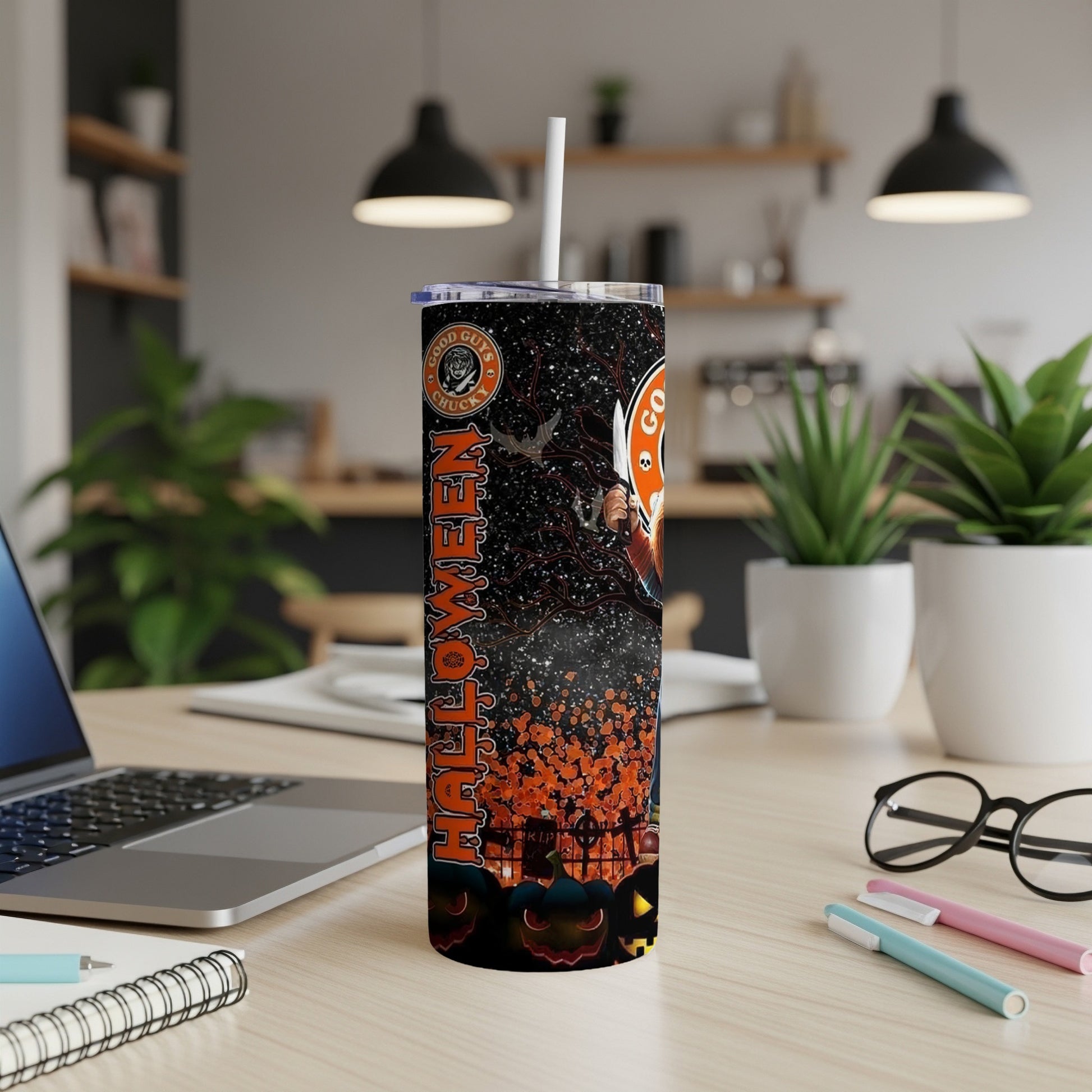 Halloween tumbler with Chucky, pumpkins, and bats, on a desk.
