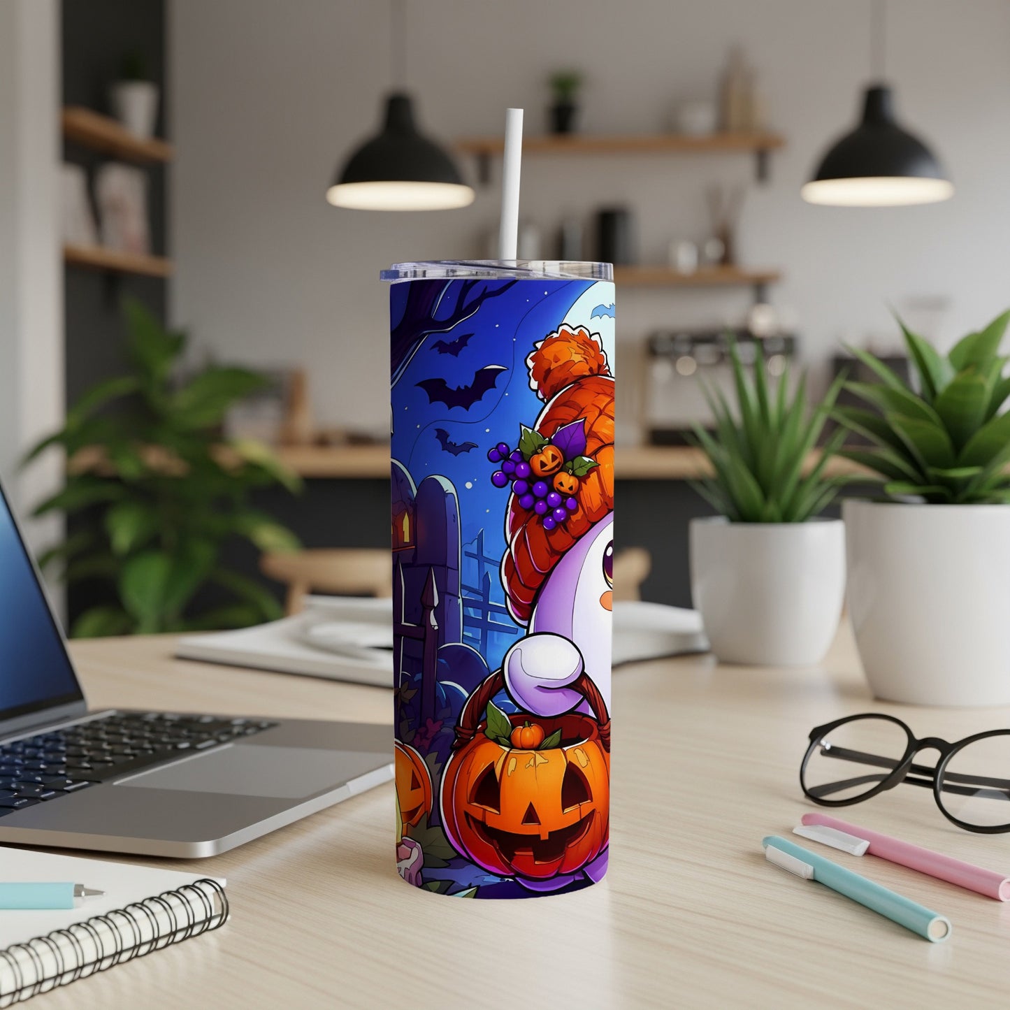 Tumbler with a ghost, pumpkins, and bats on a Halloween-themed design.